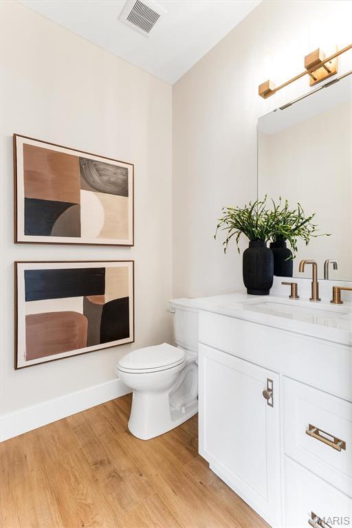 2217 Valleyview Dr, Barnhart, MO 63012 - bathroom with wood finished floors, toilet, and vanity