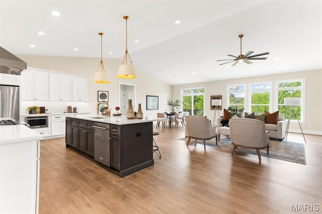 2217 Valleyview Dr, Barnhart, MO 63012 - kitchen with light countertops, vaulted ceiling, a sink, appliances with stainless steel finishes, and white cabinetry