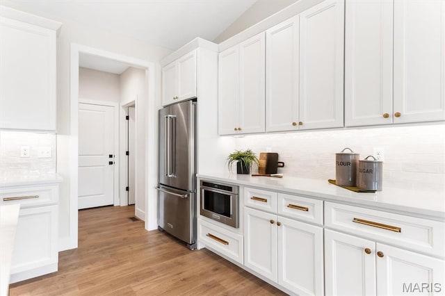 2217 Valleyview Dr, Barnhart, MO 63012 - kitchen featuring stainless steel appliances, tasteful backsplash, white cabinetry, light countertops, and light wood-type flooring