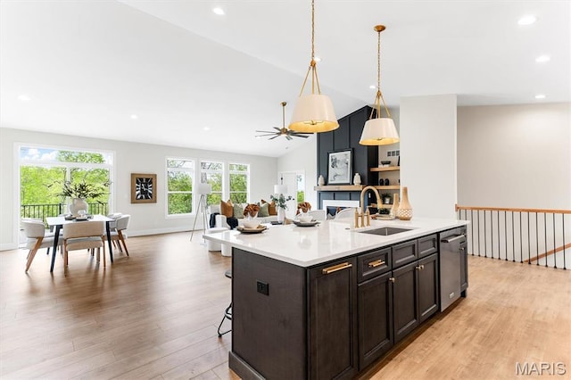 2217 Valleyview Dr, Barnhart, MO 63012 - kitchen with a sink, stainless steel dishwasher, light wood-type flooring, light countertops, and a breakfast bar area