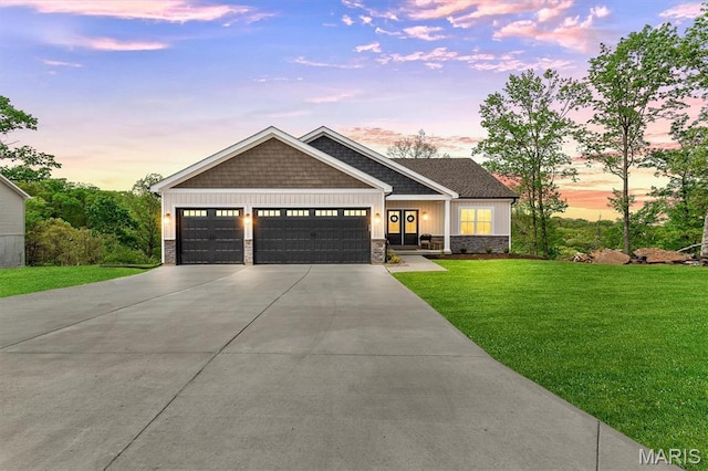 2217 Valleyview Dr, Barnhart, MO 63012 - view of front of home with stone siding, an attached garage, driveway, a front lawn, and board and batten siding