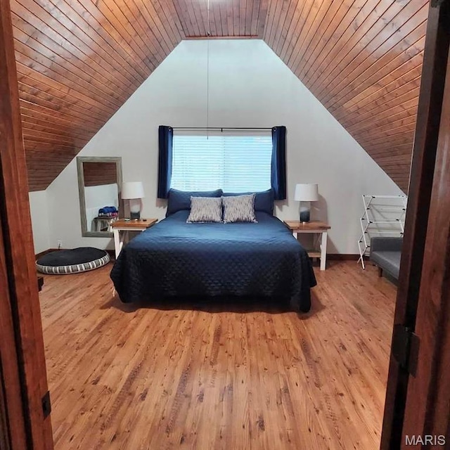 bedroom with lofted ceiling, wood finished floors, baseboards, and wood ceiling