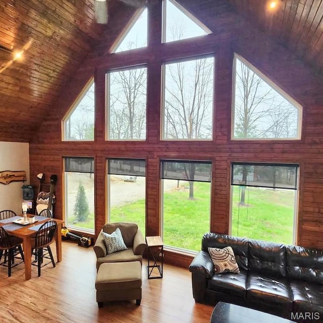 living room with high vaulted ceiling, wooden ceiling, and wood finished floors