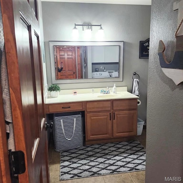 bathroom featuring a textured wall, vanity, and tile patterned floors