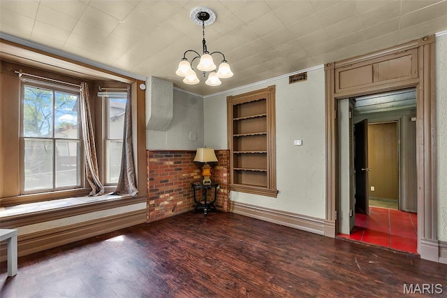 63 N Hanover St, Cape Girardeau, MO 63701 - unfurnished dining area with a chandelier, wood finished floors, and baseboards