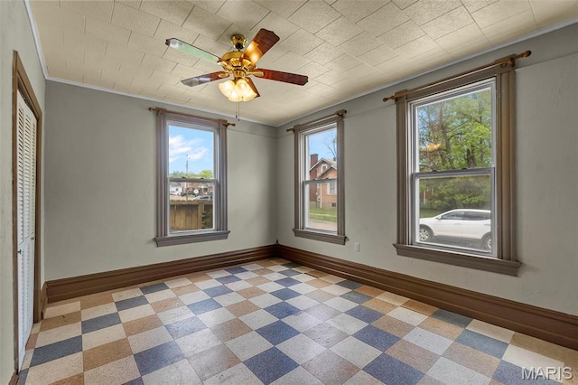 63 N Hanover St, Cape Girardeau, MO 63701 - unfurnished room featuring healthy amount of natural light, baseboards, ornamental molding, and a ceiling fan