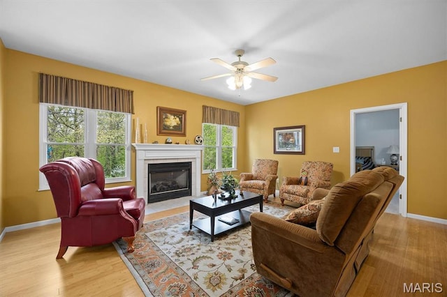 1674 Lakepointe Estates Dr, Ofallon, IL 62269 - living room with a fireplace with flush hearth, a ceiling fan, and light wood finished floors