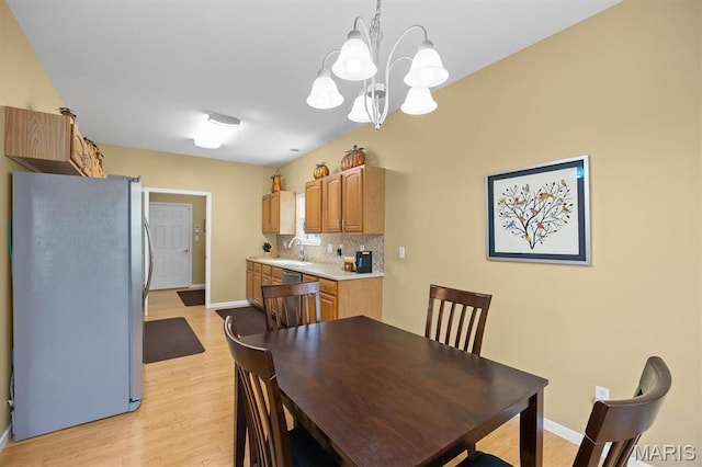 1674 Lakepointe Estates Dr, Ofallon, IL 62269 - dining space featuring a chandelier and light wood-type flooring