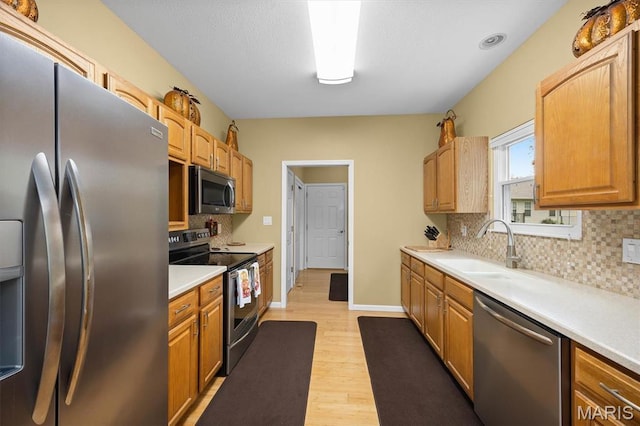 1674 Lakepointe Estates Dr, Ofallon, IL 62269 - kitchen with stainless steel appliances, light wood-style floors, light countertops, and decorative backsplash