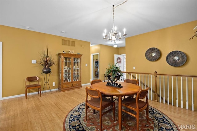 1674 Lakepointe Estates Dr, Ofallon, IL 62269 - dining space with a chandelier and wood finished floors