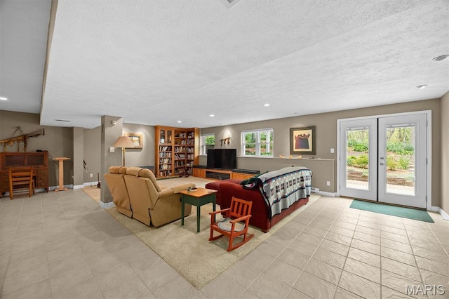 1674 Lakepointe Estates Dr, Ofallon, IL 62269 - living area with a textured ceiling, light tile patterned floors, french doors, and recessed lighting