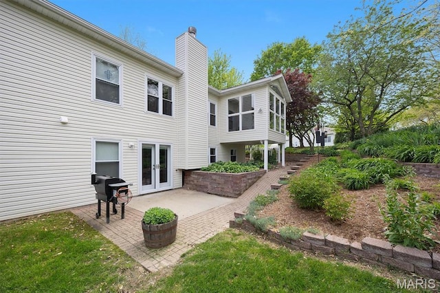 1674 Lakepointe Estates Dr, Ofallon, IL 62269 - back of property featuring a chimney, french doors, and a patio