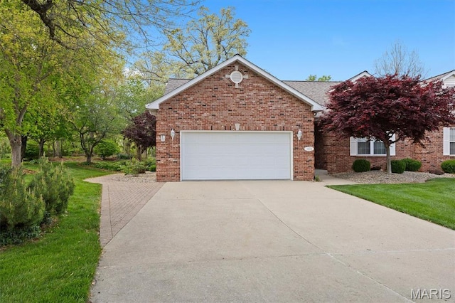 1674 Lakepointe Estates Dr, Ofallon, IL 62269 - view of front of house with driveway, an attached garage, brick siding, and a front lawn