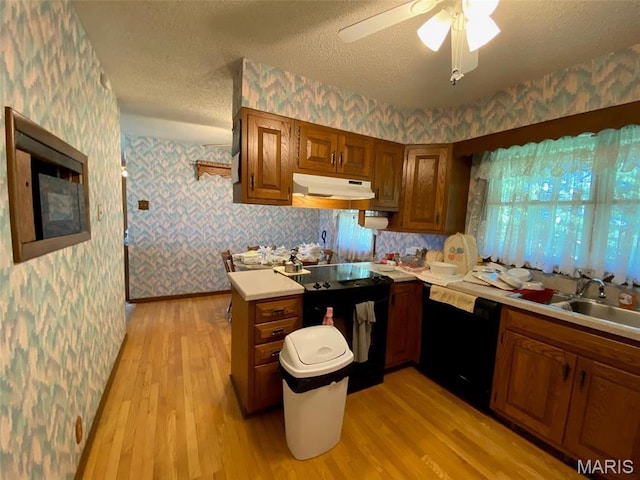 25127 N 16th Ave, Nokomis, IL 62075 - kitchen with black appliances, wallpapered walls, under cabinet range hood, brown cabinetry, and light countertops