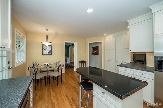 15 York Hills Dr, Saint Louis, MO 63144 - kitchen with dark countertops, white cabinetry, light wood-style floors, and recessed lighting