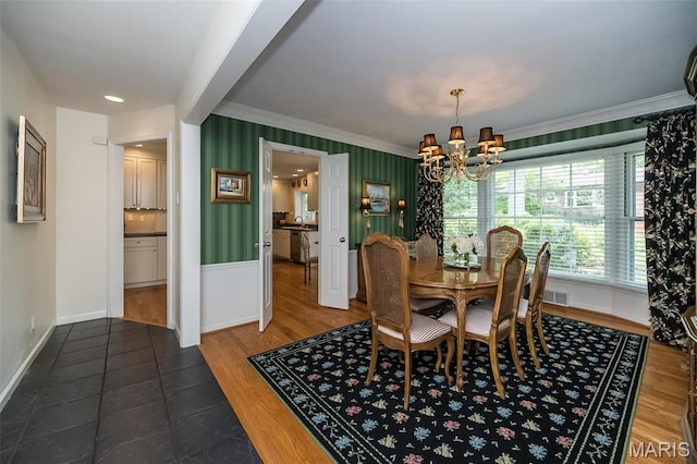 15 York Hills Dr, Saint Louis, MO 63144 - dining space featuring a chandelier, crown molding, baseboards, and wood finished floors