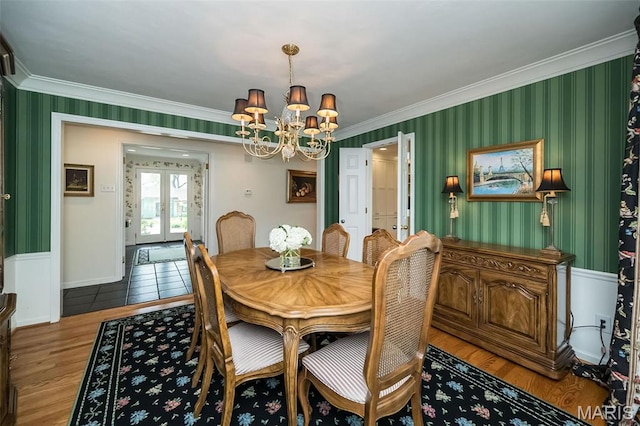 15 York Hills Dr, Saint Louis, MO 63144 - dining area featuring french doors, crown molding, a chandelier, wood finished floors, and wallpapered walls