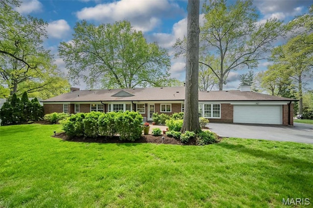 15 York Hills Dr, Saint Louis, MO 63144 - view of front facade featuring a garage, brick siding, asphalt driveway, and a front lawn
