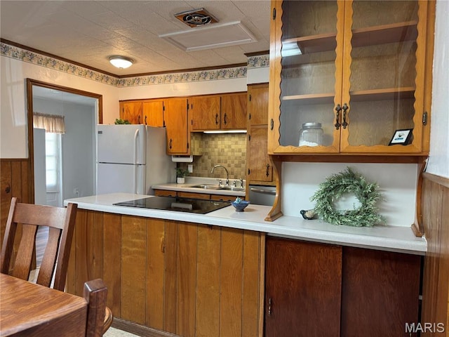 503 Frankford Rd, Louisiana, MO 63353 - kitchen featuring black electric stovetop, freestanding refrigerator, brown cabinets, light countertops, and a peninsula