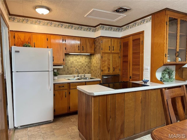 503 Frankford Rd, Louisiana, MO 63353 - kitchen with freestanding refrigerator, a sink, brown cabinets, light countertops, and black electric cooktop