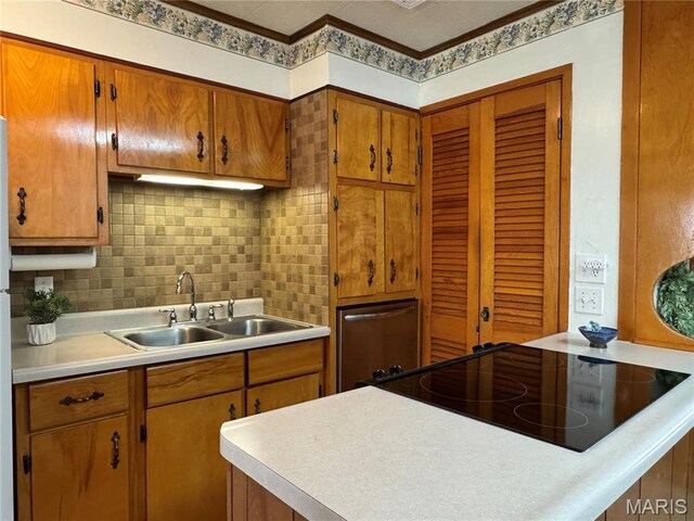 503 Frankford Rd, Louisiana, MO 63353 - kitchen featuring a sink, light countertops, backsplash, brown cabinets, and cooktop