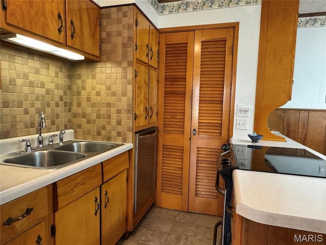 503 Frankford Rd, Louisiana, MO 63353 - kitchen with a sink, light countertops, tasteful backsplash, and brown cabinets