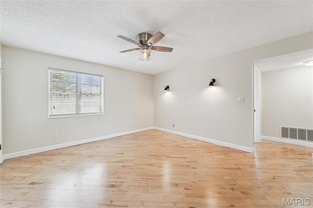 1521 Oriole Ln, Brentwood, MO 63144 - empty room with a ceiling fan, light wood-style flooring, a textured ceiling, and baseboards