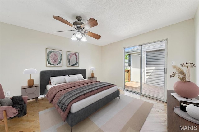1521 Oriole Ln, Brentwood, MO 63144 - bedroom featuring access to exterior, light wood-style flooring, ceiling fan, and a textured ceiling