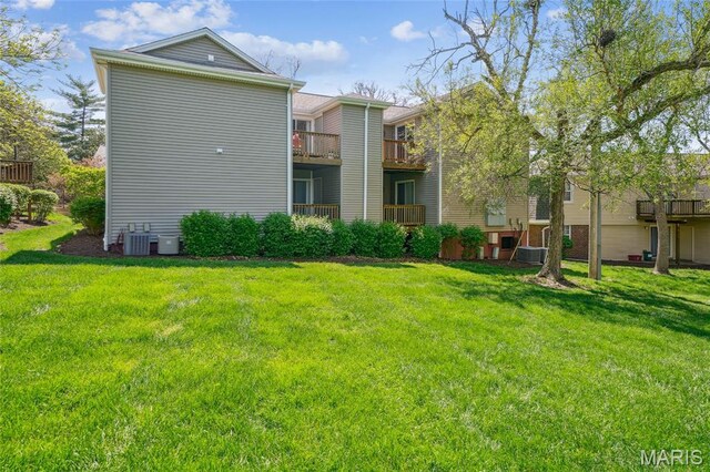 1521 Oriole Ln, Brentwood, MO 63144 - back of house with cooling unit and a lawn