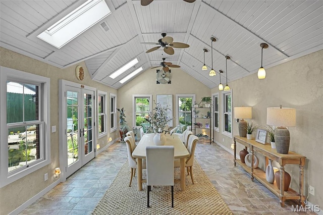 1201 Dolman St, Saint Louis, MO 63104 - dining area with ceiling fan, a skylight, stone tile floors, baseboards, and vaulted ceiling