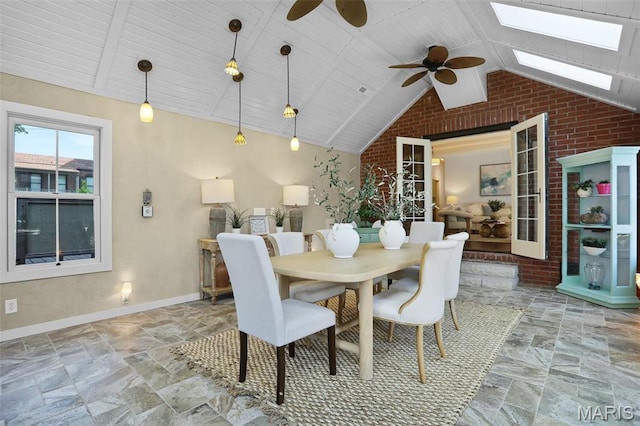 1201 Dolman St, Saint Louis, MO 63104 - dining area featuring brick wall, a skylight, stone tile floors, a ceiling fan, and lofted ceiling