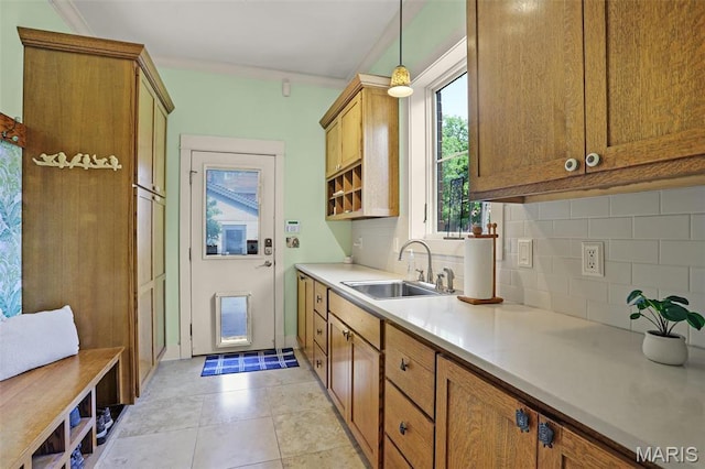 1201 Dolman St, Saint Louis, MO 63104 - kitchen with a sink, tasteful backsplash, light countertops, and brown cabinets