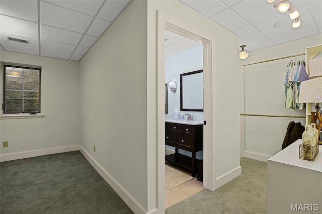 1201 Dolman St, Saint Louis, MO 63104 - corridor with a drop ceiling, carpet flooring, baseboards, and a sink