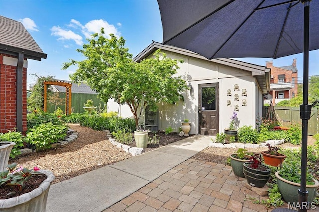 1201 Dolman St, Saint Louis, MO 63104 - property entrance featuring a patio area and stucco siding