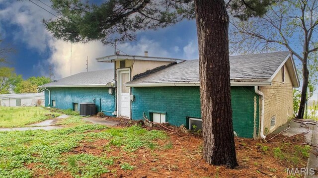 516 N Old Edwardsville Rd, Roxana, IL 62084 - back of house with brick siding, roof with shingles, and cooling unit