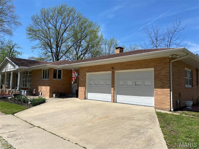 123 S Oak St, Nokomis, IL 62075 - view of front of home featuring brick siding, driveway, an attached garage, and a chimney