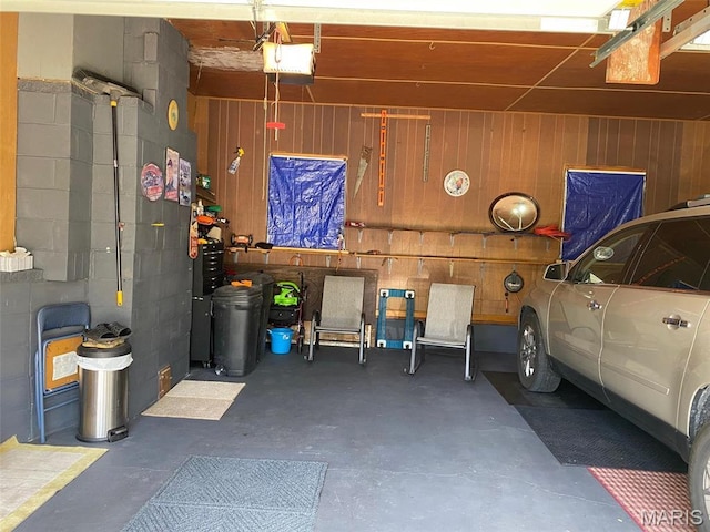 123 S Oak St, Nokomis, IL 62075 - garage featuring a garage door opener, wood walls, and concrete block wall