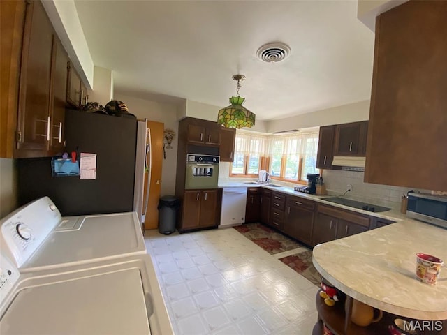 123 S Oak St, Nokomis, IL 62075 - kitchen with stainless steel appliances, light floors, light countertops, independent washer and dryer, and backsplash