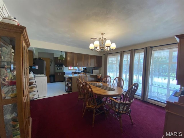 123 S Oak St, Nokomis, IL 62075 - dining area featuring a chandelier, carpet floors, and washer / clothes dryer
