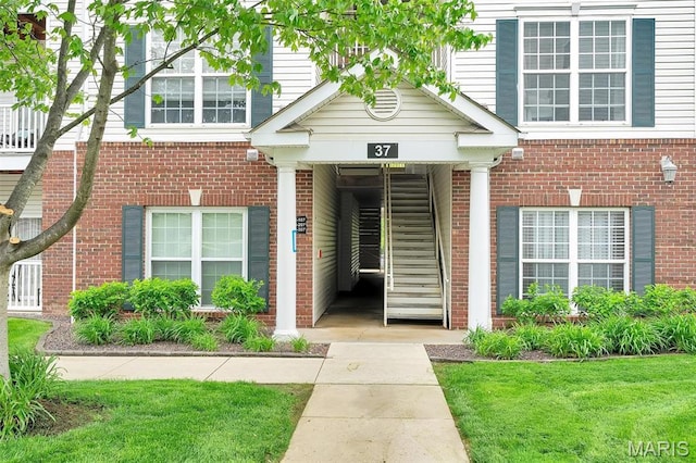 view of exterior entry with brick siding