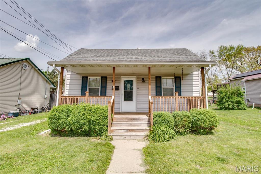 228 Ayres St, White Hall, IL 62092 - bungalow-style home featuring a porch, a front lawn, and a shingled roof