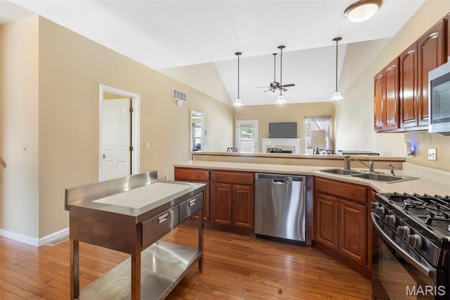 627 Rosetta Dr Unit M1, Florissant, MO 63031 - kitchen featuring stainless steel dishwasher, a sink, a ceiling fan, vaulted ceiling, and gas stove