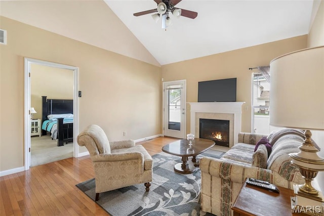 627 Rosetta Dr Unit M1, Florissant, MO 63031 - living room with ceiling fan, hardwood / wood-style floors, a glass covered fireplace, high vaulted ceiling, and baseboards