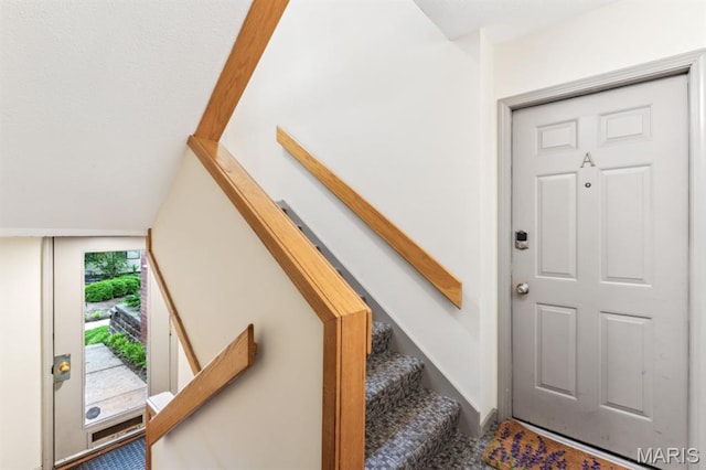 stairs featuring lofted ceiling