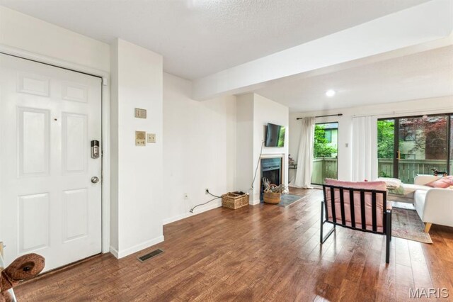 living room featuring wood finished floors, a fireplace, and baseboards