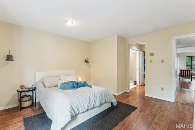 bedroom featuring wood finished floors and baseboards