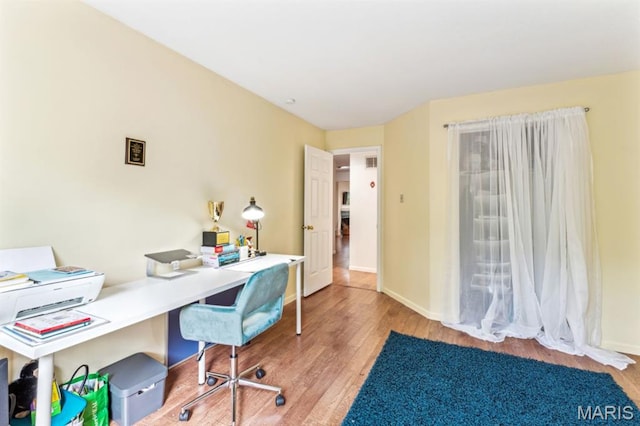 office area with wood finished floors and baseboards