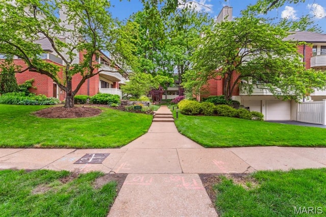 view of property's community featuring a yard