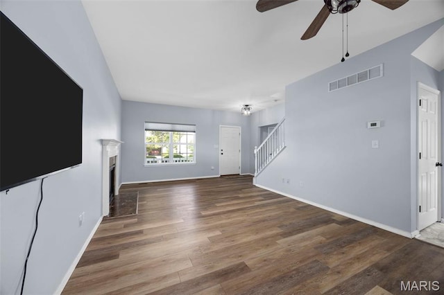 416 Briarchase Pl, Lake St Louis, MO 63367 - unfurnished living room with ceiling fan, stairs, wood finished floors, baseboards, and a fireplace with flush hearth