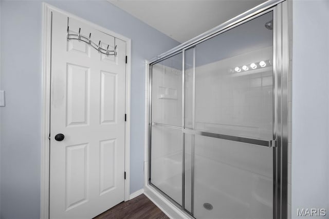 416 Briarchase Pl, Lake St Louis, MO 63367 - bathroom featuring a stall shower, wood finished floors, and baseboards